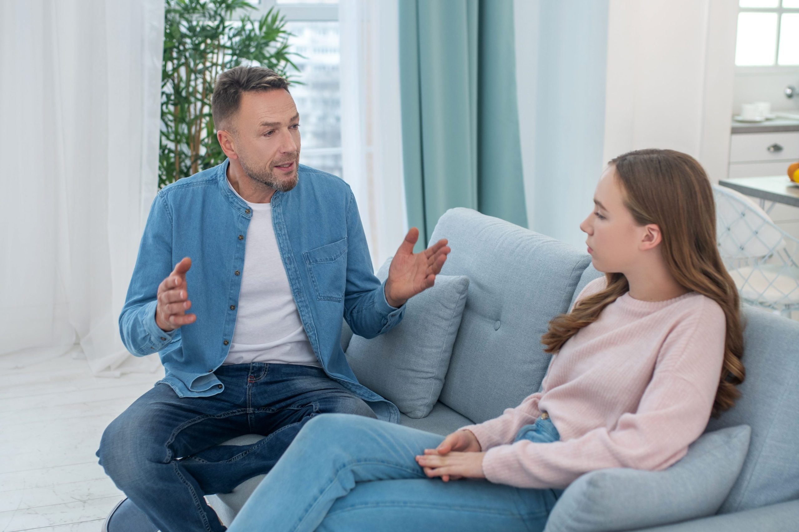 Teen and parent having a serious conversation at home