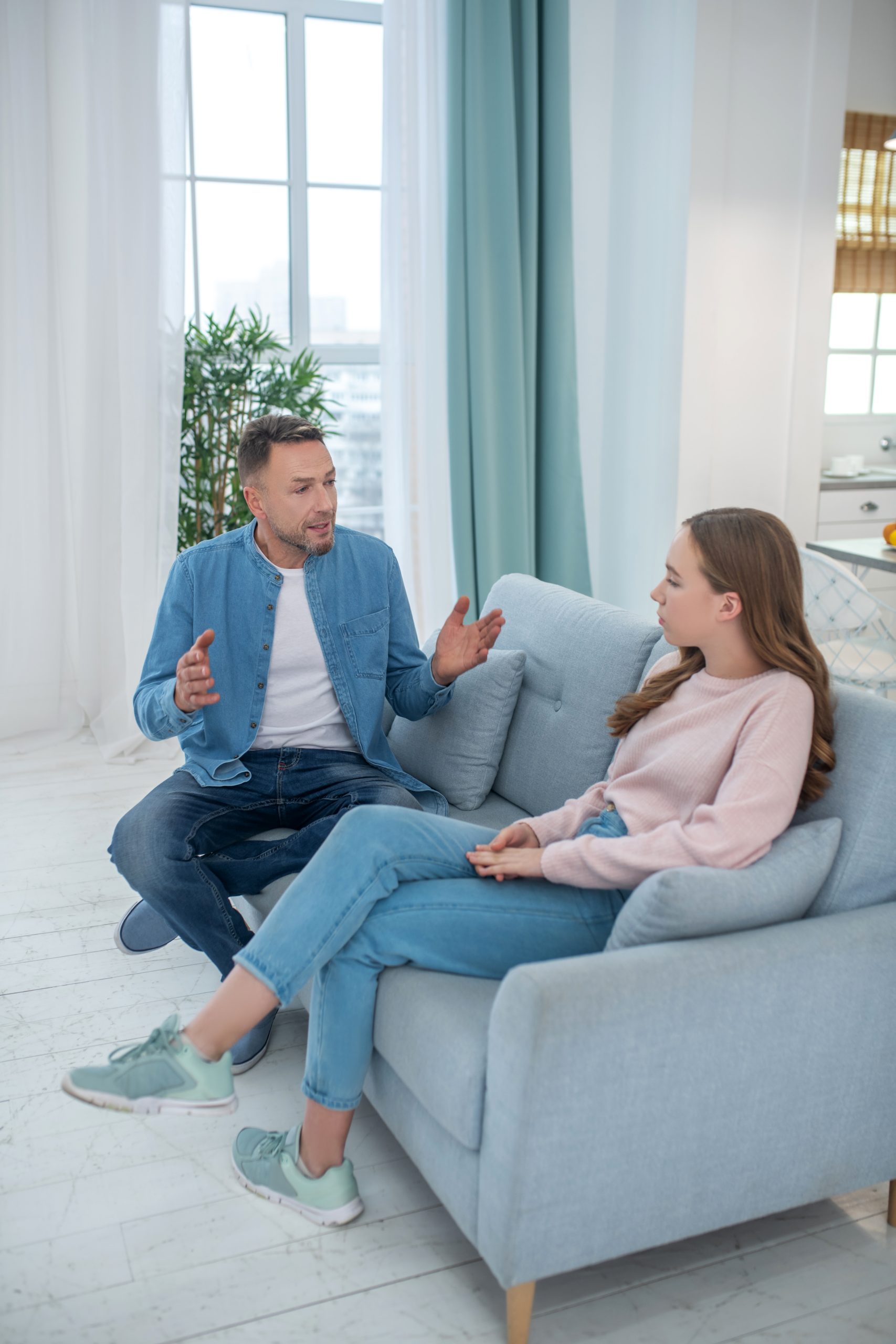 Teen and parent having a serious conversation at home