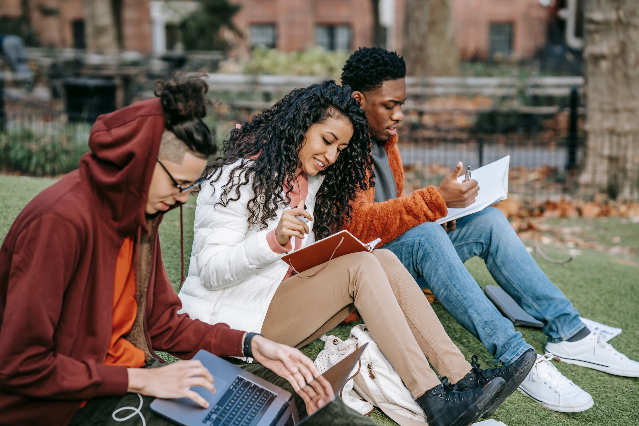 Students checking off a list while completing a college application outdoors